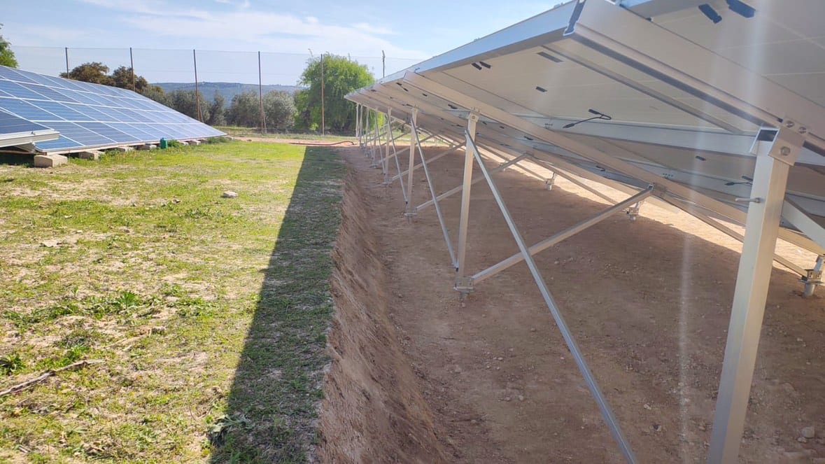 Utility-scale aluminum ground mount in grass field