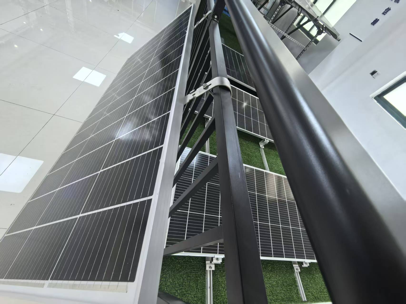 Close-up angle of solar panel on black balcony railing bracket
